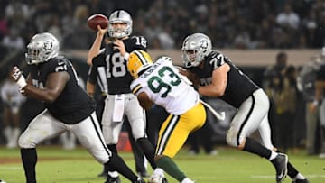 OAKLAND, CA - AUGUST 24: Connor Cook #18 of the Oakland Raiders looks to pass against the Green Bay Packers during the second quarter of an NFL preseason football game at Oakland-Alameda County Coliseum on August 24, 2018 in Oakland, California. (Photo by Thearon W. Henderson/Getty Images)