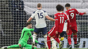 Liverpool's Brazilian midfielder Roberto Firmino (R) scores the opening goal during the English Premier League football match between Tottenham Hotspur and Liverpool at Tottenham Hotspur Stadium in London, on January 28, 2021 (Photo by CATHERINE IVILL/POOL/AFP via Getty Images)