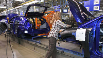 WAYNE, MI - DECEMBER 14: A worker builds a Ford Focus on the assembly line at the Ford Motor Co.'s Michigan Assembly Plant December 14, 2011 in Wayne, Michigan. Ford released details about the electrification of the Michigan Assembly Plant that will power production in part by one of the largest solar energy generator systems in order to produce their new C-MAX Hybrid and C-MAX Energi electric vehicles. (Photo by Bill Pugliano/Getty Images)