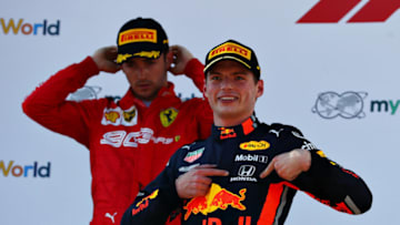SPIELBERG, AUSTRIA - JUNE 30: Race winner Max Verstappen of Netherlands and Red Bull Racing celebrates on the podium as second placed Charles Leclerc of Monaco and Ferrari looks dejected during the F1 Grand Prix of Austria at Red Bull Ring on June 30, 2019 in Spielberg, Austria. (Photo by Mark Thompson/Getty Images)
