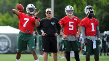 Jul 24, 2014; Cortland, NY, USA; New York Jets quarterback Geno Smith (7) passes the ball as quarterbacks coach David Lee and quarterbacks Matt Simms (5) and Michael Vick (1) look on during training camp at SUNY Cortland. Mandatory Credit: Rich Barnes-USA TODAY Sports
