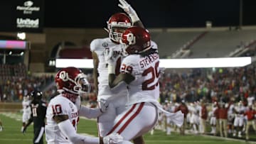 Oct 31, 2020; Lubbock, Texas, USA; Oklahoma Sooners running back Rhamondre Stevenson (29) reacts in the first half with wide receiver Theo Wease (10) and running back Seth McGowan (1) after scoring against the Texas Tech Red Raiders at Jones AT&T Stadium. Mandatory Credit: Michael C. Johnson-USA TODAY Sports