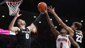 TUCSON, ARIZONA - JANUARY 13: Guard Luke O'Brien #0 of the Colorado Buffaloes, guard Bennedict Mathurin #0 of the Arizona Wildcats and forward Tristan da Silva #23 of the Colorado Buffaloes compete for a rebound during the first half of the NCAAB game at McKale Center on January 03, 2022 in Tucson, Arizona. The Arizona Wildcats lead 32-28 against the Colorado Buffaloes. (Photo by Rebecca Noble/Getty Images)