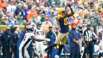 GREEN BAY, WISCONSIN - SEPTEMBER 22: Marquez Valdes-Scantling #83 of the Green Bay Packers makes a catch in front of DeVante Bausby #41 of the Denver Broncos during the second half at Lambeau Field on September 22, 2019 in Green Bay, Wisconsin. (Photo by Nuccio DiNuzzo/Getty Images)