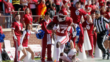 Oklahoma's Marvin Mims (17) scores a touchdown in front of Texas Tech's Malik Dunlap (8) during a college football game between the University of Oklahoma Sooners (OU) and the Texas Tech Red Raiders at Gaylord Family-Oklahoma Memorial Stadium in Norman, Okla., Saturday, Oct. 30, 2021.Ou Vc Texas Tech