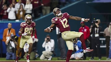 Dec 30, 2016; Miami Gardens, FL, USA; Florida State Seminoles quarterback Deondre Francois (12) celebrates after scoring a touchdown in the fourth quarter against the Michigan Wolverines at Hard Rock Stadium. Mandatory Credit: Logan Bowles-USA TODAY Sports