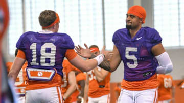 Clemson quarterback D.J. Uiagalelei(5) greets Clemson quarterback Hunter Helms(18) before warmups at football practice in Clemson, S.C. Monday, March 22, 2021.Clemson Spring Football Practice