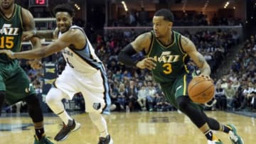 Mar 4, 2016; Memphis, TN, USA; Utah Jazz guard Trey Burke (3) dribbles as Memphis Grizzlies guard Mario Chalmers (6) looks on in the second quarter at FedExForum. Mandatory Credit: Nelson Chenault-USA TODAY Sports