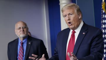 President Donald Trump flanked by Dr. Robert Redfield, (Photo by Drew Angerer/Getty Images)