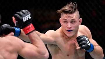 LAS VEGAS, NEVADA - MARCH 06: In this handout image provided by UFC, (R-L) Drew Dober punches Islam Makhachev in their lightweight fight during the UFC 259 event at UFC APEX on March 06, 2021 in Las Vegas, Nevada. (Photo by Jeff Bottari/Zuffa LLC via Getty Images)