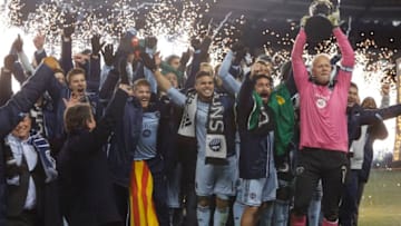 KANSAS CITY, KS - DECEMBER 7: Members of Sporting Kansas City celebrate with the trophy after winning the MLS Cup Final against the Real Salt Lake at Sporting Park on December 7, 2013 in Kansas City, Kansas. (Photo by Ed Zurga/Getty Images)