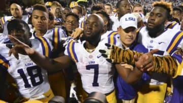 Sep 12, 2015; Starkville, MS, USA; LSU Tigers head coach Les Miles embraces running back Leonard Fournette (7) after defeating the Mississippi State Bulldogs at Davis Wade Stadium. LSU won 21-19. Mandatory Credit: Matt Bush-USA TODAY Sports
