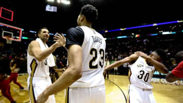 Feb 25, 2016; New Orleans, LA, USA; New Orleans Pelicans forward Anthony Davis (23) celebrates forward Ryan Anderson (33) as guard Norris Cole (30) dabs following a win against the Oklahoma City Thunder at Smoothie King Center. The Pelicans defeated the Thunder 123-119. Mandatory Credit: Derick E. Hingle-USA TODAY Sports
