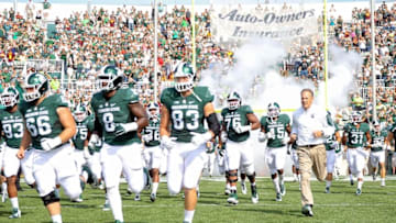 Sep 26, 2015; East Lansing, MI, USA; Michigan State Spartans head coach Mark Dantonio bring his team onto the field prior to a game against Central Michigan at Spartan Stadium. Mandatory Credit: Mike Carter-USA TODAY Sports