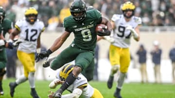 Michigan State's Kenneth Walker III avoids a tackle by Michigan's R.J. Moten during his touchdown run during the fourth quarter on Saturday, Oct. 30, 2021, at Spartan Stadium in East Lansing.