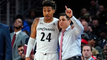 Cincinnati Bearcats head coach Wes Miller instructs guard Jeremiah Davenport at Fifth Third Arena. The Enquirer.