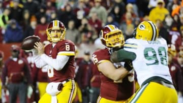 Jan 10, 2016; Landover, MD, USA; Washington Redskins quarterback Kirk Cousins (8) prepares to throw the ball over Green Bay Packers defensive end Letroy Guion (98) during the second half in a NFC Wild Card playoff football game at FedEx Field. Mandatory Credit: Brad Mills-USA TODAY Sports