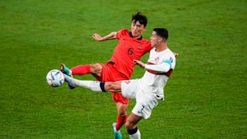 AL RAYYAN, QATAR - DECEMBER 02: Inbeom Hwang of Korea (L) battles for the ball with Cristiano Ronaldo of Portugal (R) during the FIFA World Cup Qatar 2022 Group H match between Korea Republic and Portugal at Education City Stadium on December 2, 2022 in Al Rayyan, Qatar. (Photo by Geovaine Oliveira/Eurasia Sport Images/Getty Images)