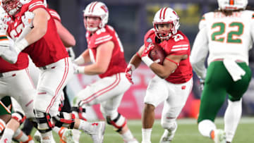 NEW YORK, NEW YORK - DECEMBER 27: Jonathan Taylor #23 of the Wisconsin Badgers runs with the ball in the first quarter of the New Era Pinstripe Bowl against the Miami Hurricanes at Yankee Stadium on December 27, 2018 in the Bronx borough of New York City. (Photo by Sarah Stier/Getty Images)