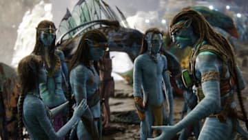 (L-R): Tsireya (Bailey Bass), Neytiri (Zoe Saldana), Neteyam (Jamie Flatters), Lo'ak (Britain Dalton), and Jake Sully (Sam Worthington) in 20th Century Studios' AVATAR: THE WAY OF WATER. Photo courtesy of 20th Century Studios. © 2022 20th Century Studios. All Rights Reserved.