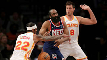 Nov 3, 2021; Brooklyn, New York, USA; Atlanta Hawks forward Cam Reddish (22) knocks the ball away from Brooklyn Nets guard James Harden (13) in front of Hawks forward Danilo Gallinari (8) during the second quarter at Barclays Center. Mandatory Credit: Brad Penner-USA TODAY Sports