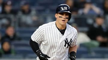 NEW YORK, NY - APRIL 16: Tyler Austin #26 of the New York Yankees is walked with the bases loaded scoring teammate Aaron Judge in the first inning against the Miami Marlins at Yankee Stadium on April 16, 2018 in the Bronx borough of New York City. (Photo by Elsa/Getty Images)