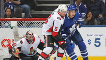 Cody Ceci #5 of the Ottawa Senators battles against Zach Hyman #11 of the Toronto Maple Leafs during an NHL game at Scotiabank Arena.(Photo by Claus Andersen/Getty Images)