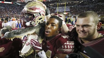 TALLAHASSEE, FL - NOVEMBER 26: DeMarcus Walker #44 of the Florida State Seminoles carries a gator head wearing his helmet as he celebrates after the game against the Florida Gators at Doak Campbell Stadium on November 26, 2016 in Tallahassee, Florida. Florida State defeated Florida 31-13. (Photo by Joe Robbins/Getty Images)