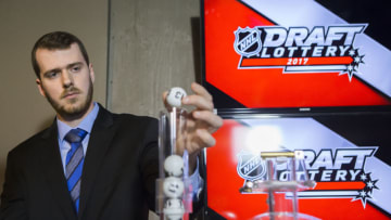 TORONTO, ON - APRIL 29: NHL official loads the lottery ball machine during the NHL Draft Lottery at the CBC Studios in Toronto, Ontario, Canada on April 29, 2017. (Photo by Kevin Sousa/NHLI via Getty Images)