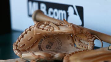 SAN FRANCISCO, CA - JULY 26: A bat and glove sit in the Oakland Athletics dugout before the game against the San Francisco Giants at AT