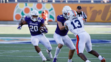 Auburn footballJan 1, 2021; Orlando, FL, USA; Northwestern Wildcats wide receiver Riley Lees (19) blocks Auburn Tigers defensive back Ladarius Tennison (13) as running back Cam Porter (20) runs the ball during the second half at Camping World Stadium. Mandatory Credit: Reinhold Matay-USA TODAY Sports