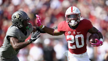 PALO ALTO, CA - OCTOBER 22: Bryce Love #20 of the Stanford Cardinal tries to run away from Chidobe Awuzie #4 of the Colorado Buffaloes at Stanford Stadium on October 22, 2016 in Palo Alto, California. (Photo by Ezra Shaw/Getty Images)
