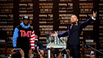 LOS ANGELES, CA - JULY 11: Floyd Mayweather Jr. and Conor McGregor faceoff on stage during the Floyd Mayweather Jr. v Conor McGregor World Press Tour at Staples Center on July 11, 2017 in Los Angeles, California. (Photo by Harry How/Getty Images)