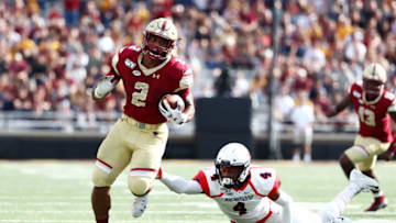 CHESTNUT HILL, MASSACHUSETTS - SEPTEMBER 07: AJ Dillon #2 of the Boston College Eagles carries the ball as Brandon Feamster #4 of the Richmond Spiders is unable to make the tackle during the first half at Alumni Stadium on September 07, 2019 in Chestnut Hill, Massachusetts. (Photo by Tim Bradbury/Getty Images)