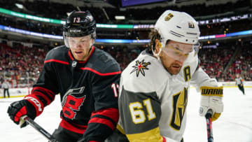 RALEIGH, NC - JANUARY 31: Carolina Hurricanes Right Wing Warren Foegele (13) and Vegas Golden Knights Right Wing Mark Stone (61) battle for a puck along the boards during a game between the Carolina Hurricanes and the Las Vegas Golden Knights on January 31, 2020 at the PNC Arena in Raleigh, NC. (Photo by Greg Thompson/Icon Sportswire via Getty Images)
