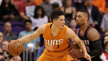 PHOENIX, AZ - MARCH 12: Devin Booker #1 of the Phoenix Suns handels the ball against Damian Lillard #0 of the Portland Trail Blazers during the second half of the NBA game at Talking Stick Resort Arena on March 12, 2017 in Phoenix, Arizona. The Trailblazers defeated the Suns 110-101. NOTE TO USER: User expressly acknowledges and agrees that, by downloading and or using this photograph, User is consenting to the terms and conditions of the Getty Images License Agreement. (Photo by Christian Petersen/Getty Images)