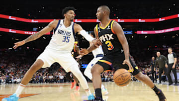 PHOENIX, ARIZONA - OCTOBER 19: Chris Paul #3 of the Phoenix Suns handles the ball against Christian Wood #35 of the Dallas Mavericks during the second half of the NBA game at Footprint Center on October 19, 2022 in Phoenix, Arizona. The Suns defeated the Mavericks 107-105. NOTE TO USER: User expressly acknowledges and agrees that, by downloading and or using this photograph, User is consenting to the terms and conditions of the Getty Images License Agreement. (Photo by Christian Petersen/Getty Images)