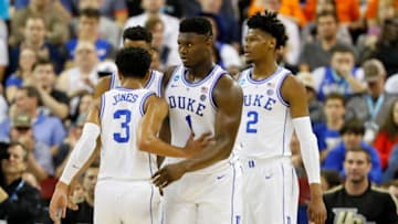 COLUMBIA, SOUTH CAROLINA - MARCH 24: Zion Williamson #1 of the Duke Blue Devils reacts with Tre Jones #3 after a basket against the UCF Knights during the first half in the second round game of the 2019 NCAA Men's Basketball Tournament at Colonial Life Arena on March 24, 2019 in Columbia, South Carolina. (Photo by Kevin C. Cox/Getty Images)