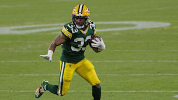 GREEN BAY, WISCONSIN - DECEMBER 06: Aaron Jones #33 of the Green Bay Packers runs for yards during a game against the Philadelphia Eagles at Lambeau Field on December 06, 2020 in Green Bay, Wisconsin. The Packers defeated the Eagles 30-16. (Photo by Stacy Revere/Getty Images)
