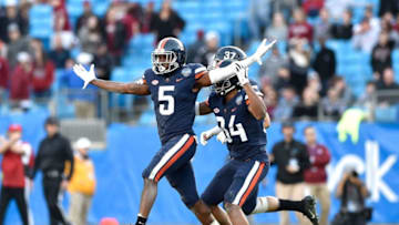 CHARLOTTE, NORTH CAROLINA - DECEMBER 29: Tim Harris #5 of the Virginia Cavaliers reacts after intercepting a pass against the South Carolina Gamecocks during the Belk Bowl at Bank of America Stadium on December 29, 2018 in Charlotte, North Carolina. Virginia won 28-0. (Photo by Grant Halverson/Getty Images)