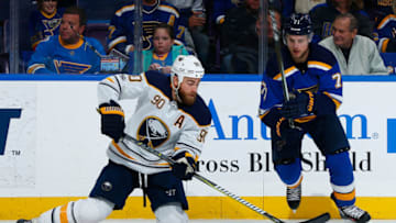 ST. LOUIS, MO - DECEMBER 10: Ryan O'Reilly #90 of the buffalo Sabres clears the puck against Vladimir Sobotka #71 of the St. Louis Blues at Scottrade Center on December 10, 2017 in St. Louis, Missouri. (Photo by Dilip Vishwanat/NHLI via Getty Images)
