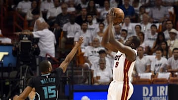 May 1, 2016; Miami, FL, USA; Miami Heat forward Luol Deng (9) makes a three point basket over Charlotte Hornets guard Kemba Walker (15) during the first half in game seven of the first round of the NBA Playoffs at American Airlines Arena. Mandatory Credit: Steve Mitchell-USA TODAY Sports