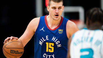 CHARLOTTE, NORTH CAROLINA - MARCH 28: Nikola Jokic #15 of the Denver Nuggets brings the ball up court while guarded by Terry Rozier #3 of the Charlotte Hornets in the fourth quarter at Spectrum Center on March 28, 2022 in Charlotte, North Carolina. NOTE TO USER: User expressly acknowledges and agrees that, by downloading and or using this photograph, User is consenting to the terms and conditions of the Getty Images License Agreement. (Photo by Jacob Kupferman/Getty Images)