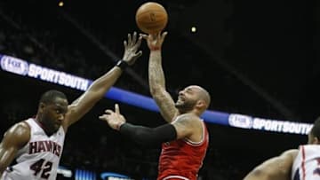 Feb 25, 2014; Atlanta, GA, USA; Chicago Bulls power forward Carlos Boozer (5) shoots the ball over Atlanta Hawks power forward Elton Brand (42) in the first quarter at Philips Arena. Mandatory Credit: Brett Davis-USA TODAY Sports