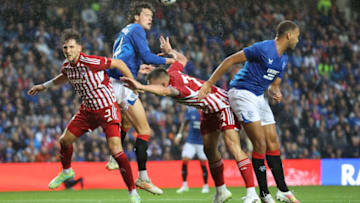 GLASGOW, SCOTLAND - JULY 26: Sam Lammers of Rangers goes up with Andreas Richardos during the end of the pre-season friendly match between Rangers and Olympiacos at Ibrox Stadium on July 26, 2023 in Glasgow, Scotland. (Photo by Steve Welsh/Getty Images)