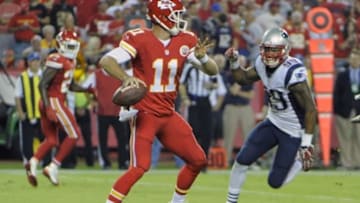 Sep 29, 2014; Kansas City, MO, USA; Kansas City Chiefs quarterback Alex Smith (11) drops back to pass against the New England Patriots in the first half at Arrowhead Stadium. Mandatory Credit: John Rieger-USA TODAY Sports
