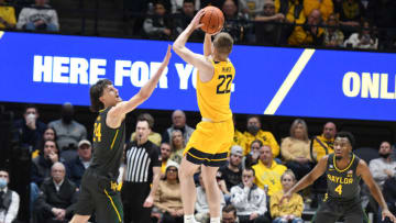 MORGANTOWN, WEST VIRGINIA - JANUARY 18: Sean McNeil #22 of the West Virginia Mountaineers takes a jump shot over Matthew Mayer #24 of the Baylor Bears during a college basketball game at the WVU Coliseum on January 18, 2022 in Morgantown, West Virginia. (Photo by Mitchell Layton/Getty Images)