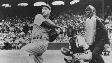 American baseball player Joe DiMaggio (1914 - 1999) hits out. Original Publication: People Disc - HC0062 (Photo by Keystone/Getty Images)