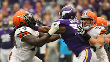 MINNEAPOLIS, MN - SEPTEMBER 22: Everson Griffen #97 of the Minnesota Vikings puts the block on Oniel Cousins #75 of the Cleveland Browns on September 22, 2013 at Mall of America Field at the Hubert Humphrey Metrodome in Minneapolis, Minnesota. (Photo by Adam Bettcher/Getty Images)