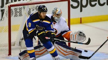 Oct 24, 2015; St. Louis, MO, USA; St. Louis Blues center Steve Ott (9) looks to deflect the puck as New York Islanders goalie Thomas Greiss (1) defends the net during the third period at Scottrade Center. New York defeated St. Louis 3-2 in overtime. Mandatory Credit: Jeff Curry-USA TODAY Sports